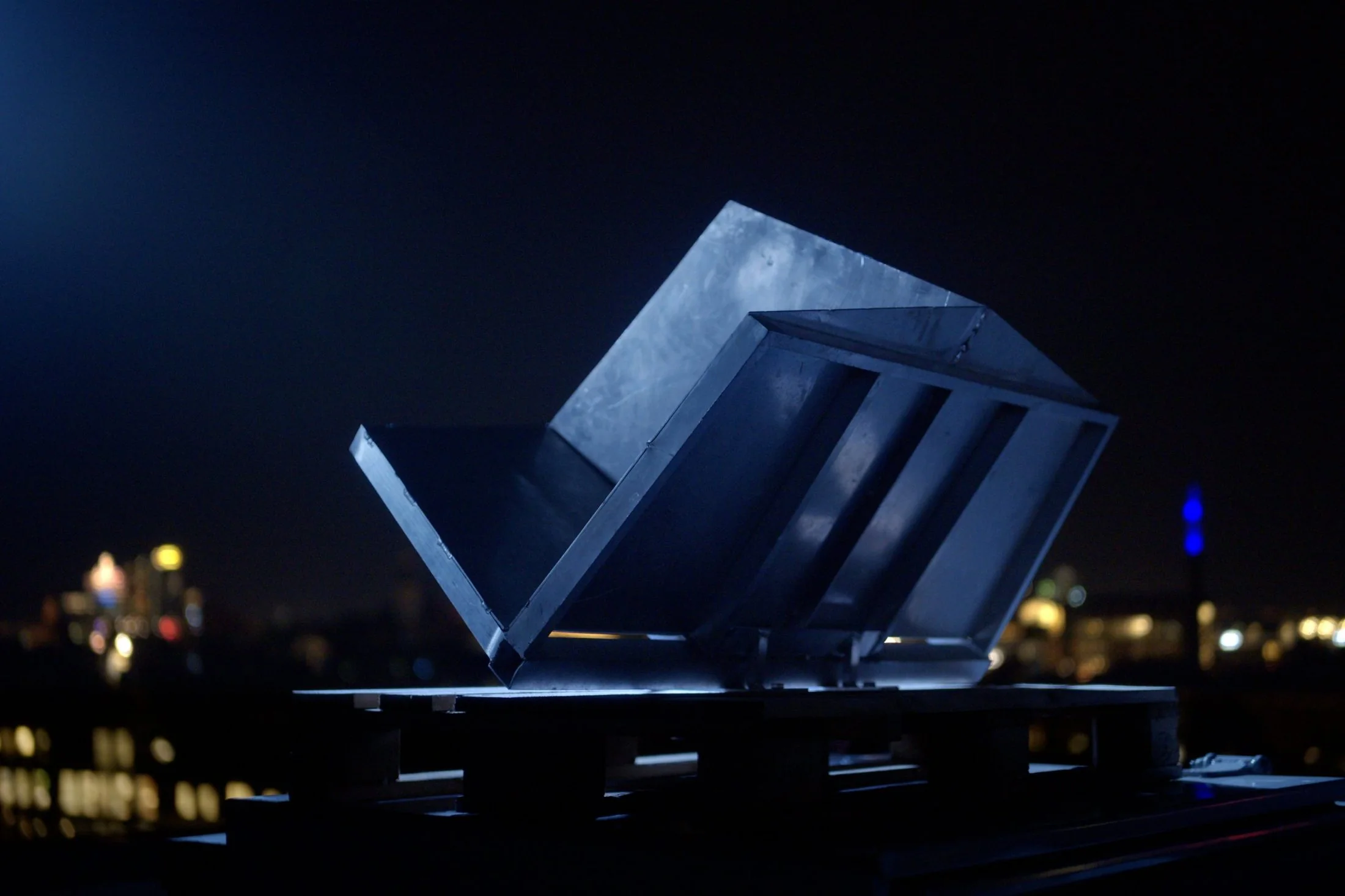 Close-up of the aluminium radar reflector of Beat of the City on an Amsterdam rooftop at night